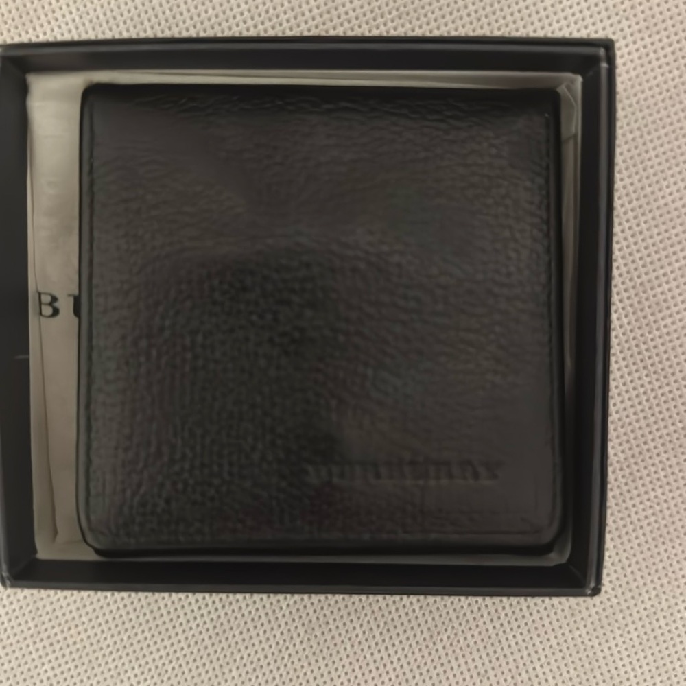 Black Burberry coin pouch.